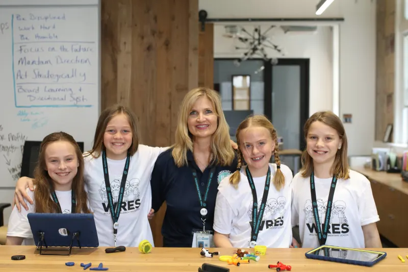 Librarian with four students holding books